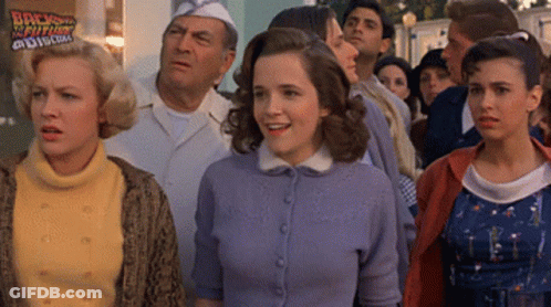Group Of People In Front Of Back To The Future Sign GIF