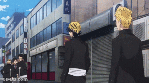 Group Of People In Front Of Building With Sign A GIF