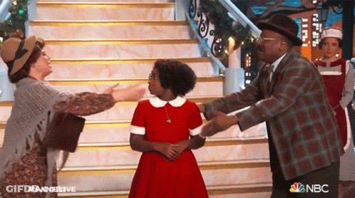 Group Of People In Front Of Stairs With NBC Logo GIF