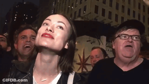 Group Of People In Front Of Star Building GIF