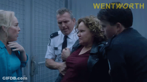 Group Of People In Front Of Wentworth Fence GIF