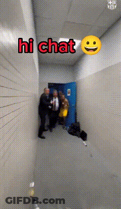 Group Of People In Hallway With Smiley Face Saying Hi Chat GIF