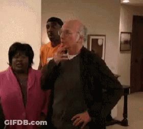Group Of People In Living Room With Smoking Man GIF