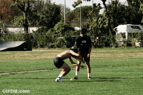 Group Of People In Purple Shirts On Grassy Field GIF