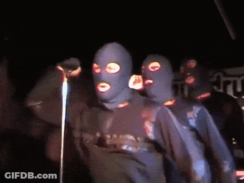 Group Of People In Ski Masks At Microphone GIF