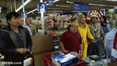 Group Of People In Store With Exit Sign GIF