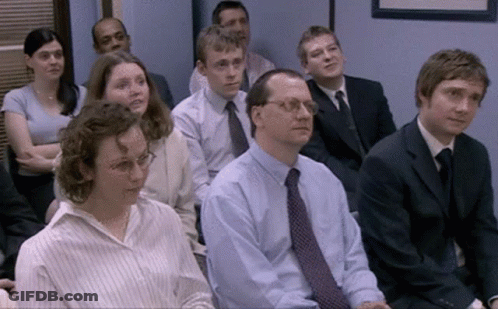 Group Of People In Suits Sitting In A Row GIF