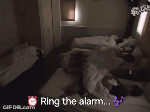 Group Of People Laying On Bed Ring The Alarm GIF