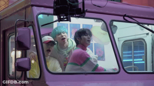 Group Of People Looking Out Of Purple Bus GIF