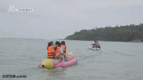 Group Of People On A Banana Boat In The Ocean GIF