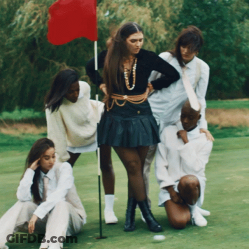 Group Of People On Golf Course With Red Flag GIF