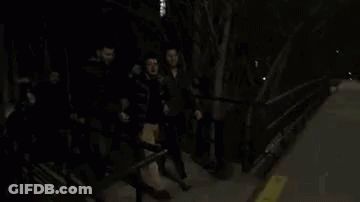 Group Of People On Sidewalk At Night GIF