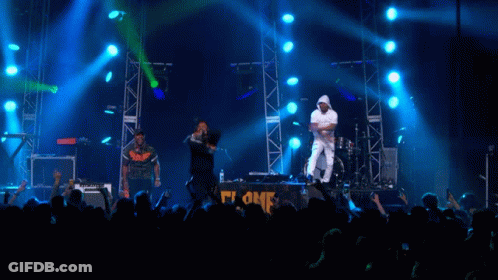 Group Of People On Stage With Blue Lights GIF