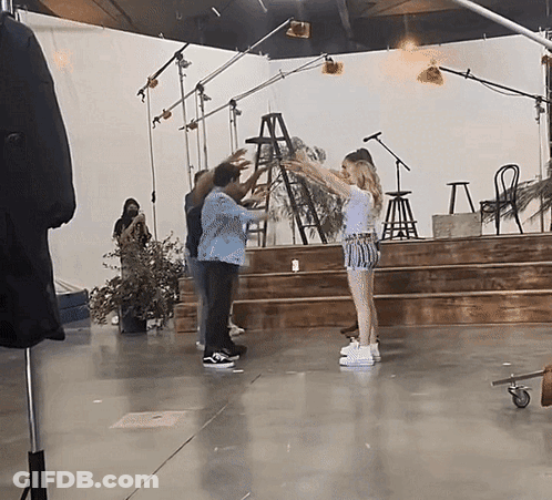 Group Of People On Stage With Ladder GIF
