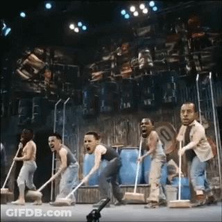 Group Of People On Stage With Mops GIF