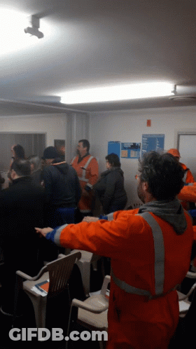 Group Of People One Man In Orange Vest GIF