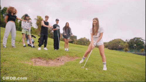 Group Of People Playing Golf On Grassy Hill GIF