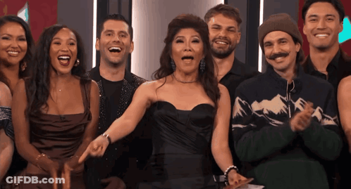 Group Of People Posing With Woman Pointing GIF