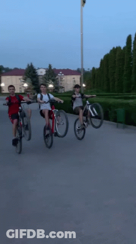 Group Of People Riding Bicycles On Street GIF