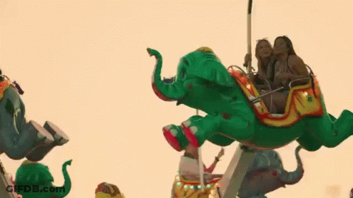 Group Of People Riding Elephant At Carnival GIF