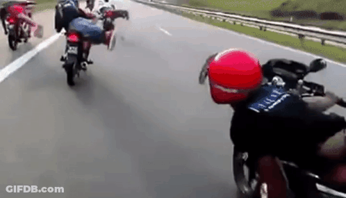 Group Of People Riding Motorcycles Down Highway GIF