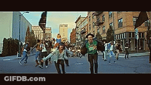 Group Of People Running Down City Street Holding Hands GIF