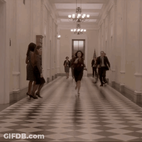 Group Of People Running Down Hallway GIF
