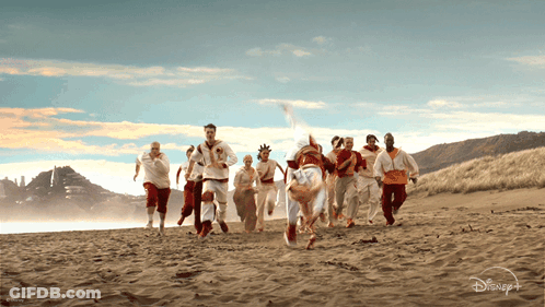 Group Of People Running On Beach With Disney Logo GIF
