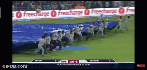 Group Of People Running On Field With Freecharge Ads GIF