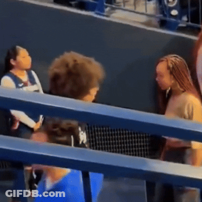 Group Of People Sitting And Talking In Stadium GIF