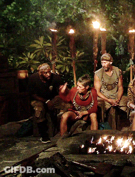 Group Of People Sitting Around Fire Pit At Night GIF