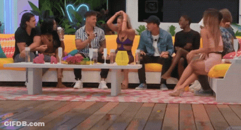 Group Of People Sitting Around Table On Deck GIF