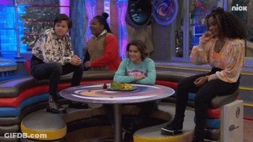 Group Of People Sitting Around Table With Nick Logo GIF