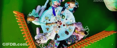 Group Of People Sitting Around Table With Plates Of Food GIF