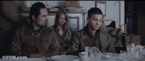 Group Of People Sitting At Table In Living Room GIF
