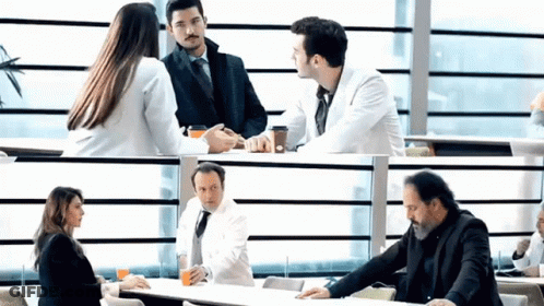 Group Of People Sitting At Table Talking GIF