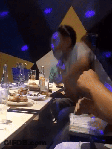Group Of People Sitting At Table With Food And Drinks GIF
