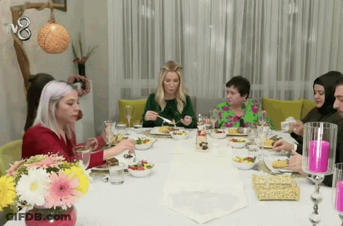 Group Of People Sitting At Table With TV8 GIF