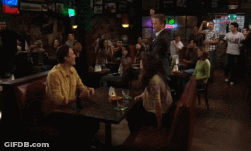 Group Of People Sitting At Tables In A Bar GIF