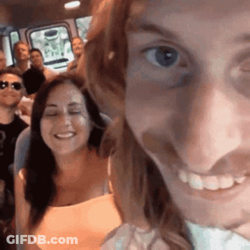 Group Of People Sitting In Bus Woman Smiling At Camera GIF