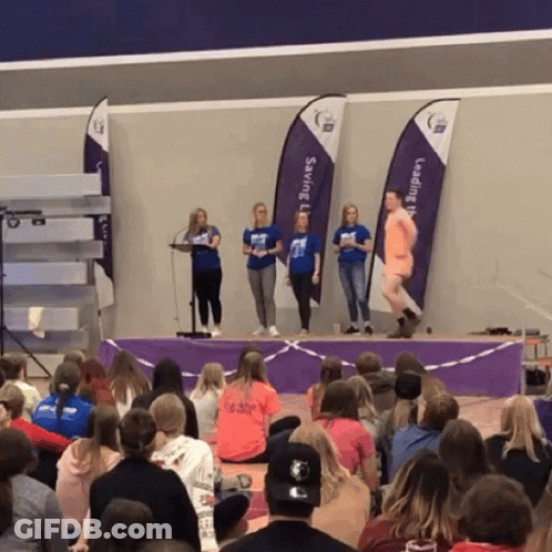Group Of People Sitting In Front Of Saving Flags GIF