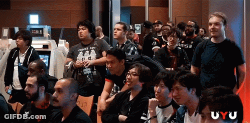 Group Of People Sitting In Room With Uyu GIF