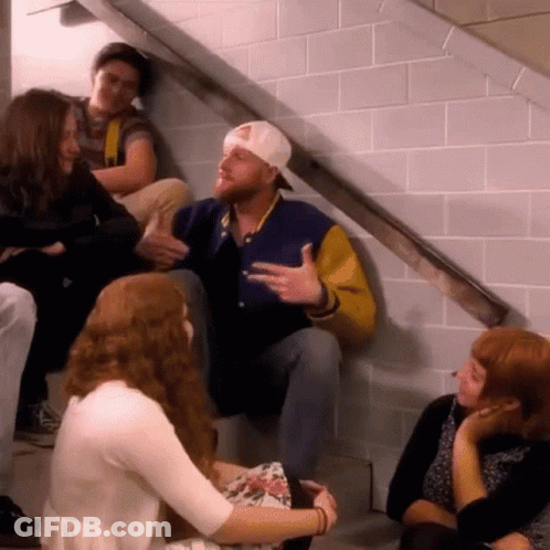 Group Of People Sitting On Stairs Talking GIF