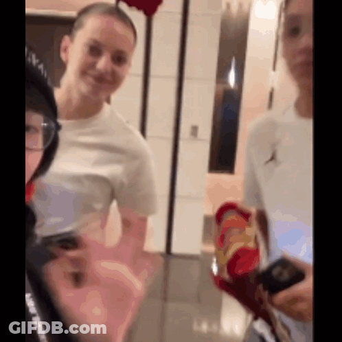 Group Of People Standing And Talking In Room GIF