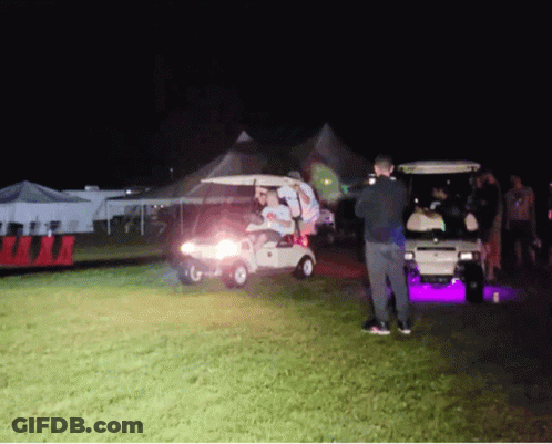 Group Of People Standing Around Golf Cart GIF