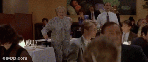 Group Of People Standing Around Table Saying Help Is On The Way GIF
