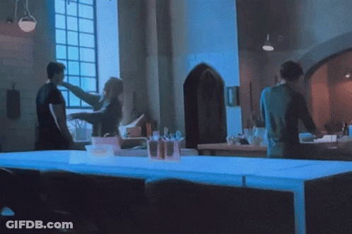 Group Of People Standing Around Table GIF
