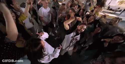 Group Of People Standing Around Woman In Crowd GIF