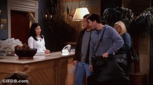 Group Of People Standing At Hotel Lobby Counter GIF
