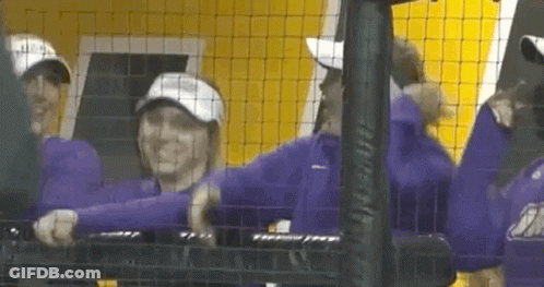 Group Of People Standing Behind Fence GIF